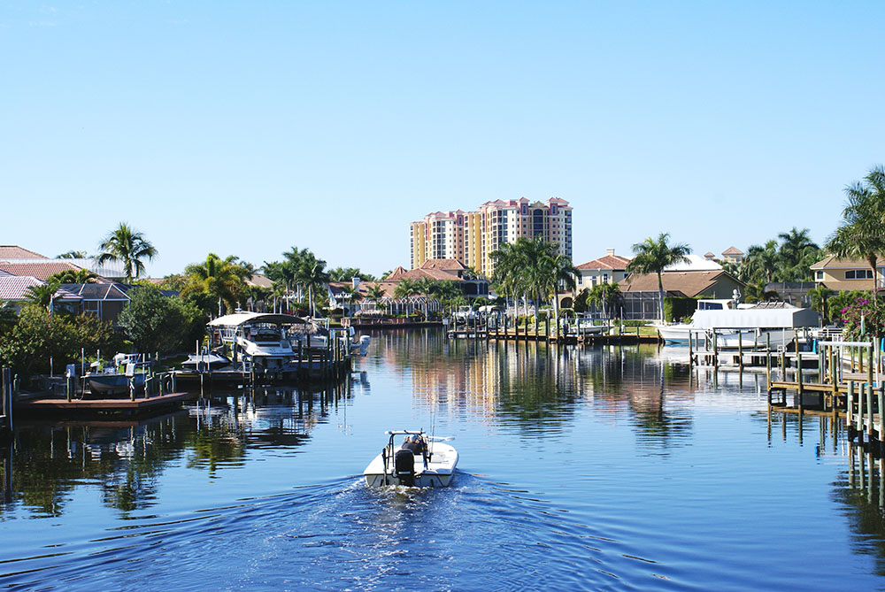 Cape Coral Property Management - boating along a canal in Cape Coral, FL